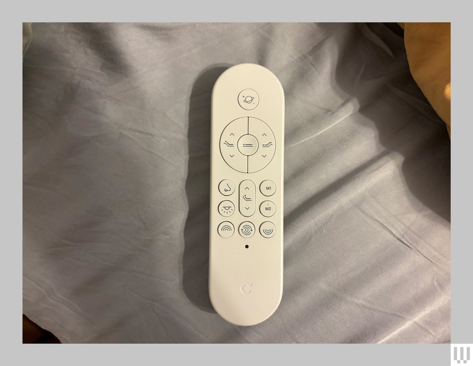 White ovalshaped remote to control an adjustable bed