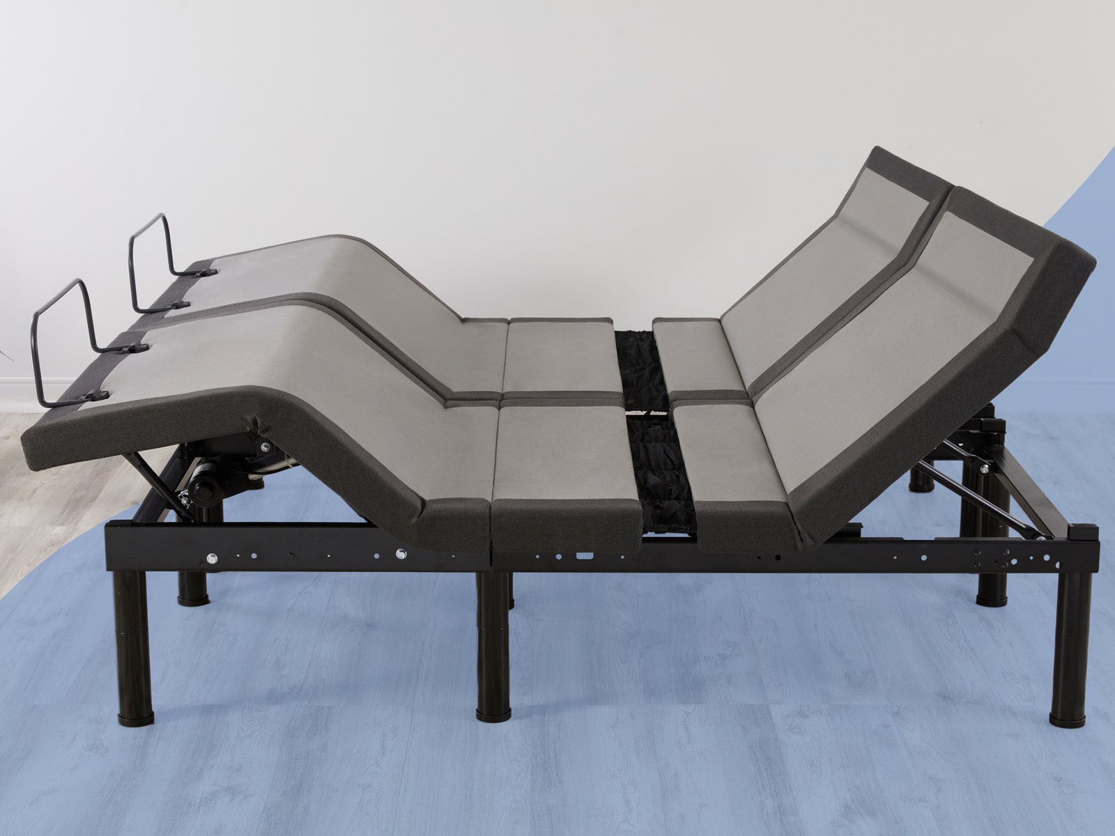 Side view of a mechanical bedframe with 2 separate vertical zones each with the ability to bend toward the bottom and...